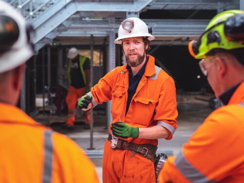 A worker giving instructions to colleagues