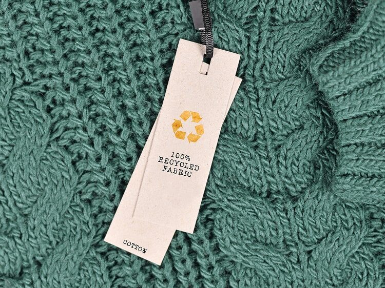 Close up image of a clothing tag, sharing the recycled elements.