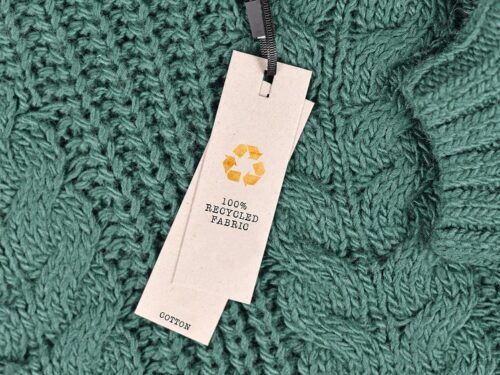 Close up image of a clothing tag, sharing the recycled elements.